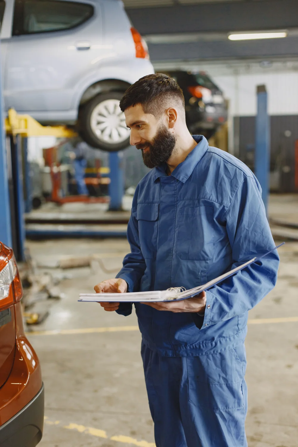 Mechanic reviewing service documents and the repair plan